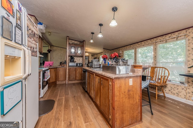 206 Briar Creek Way, Lizella, GA 31052 - kitchen featuring white refrigerator with ice dispenser, brown cabinetry, stainless steel dishwasher, light wood-type flooring, and a textured ceiling