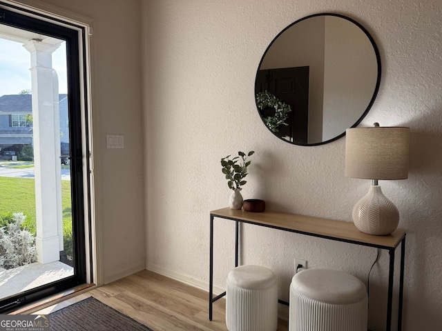 3836 Saddle Hill Way, Douglasville, GA 30135 - doorway to outside featuring a textured wall, wood finished floors, and baseboards