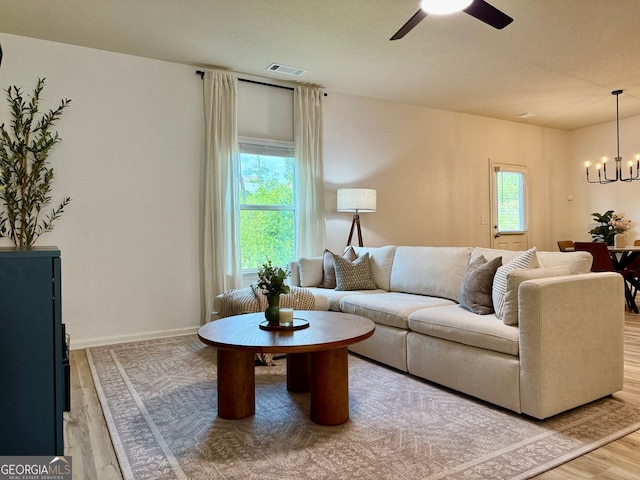 3836 Saddle Hill Way, Douglasville, GA 30135 - living area with wood finished floors, a ceiling fan, healthy amount of natural light, and a chandelier