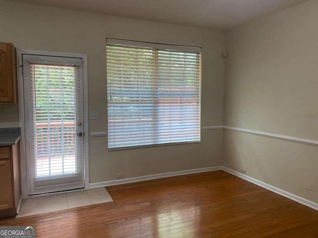 2858 Parkway Close, Lithonia, GA 30058 - unfurnished dining area featuring light wood finished floors, baseboards, and plenty of natural light
