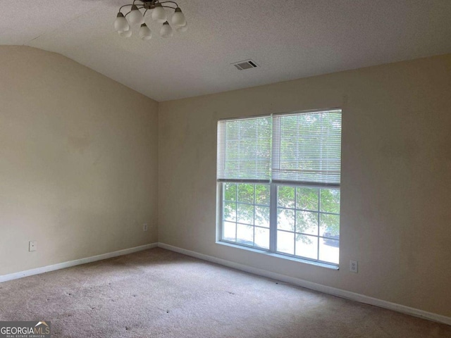 2858 Parkway Close, Lithonia, GA 30058 - unfurnished room with a chandelier, carpet floors, vaulted ceiling, baseboards, and a textured ceiling