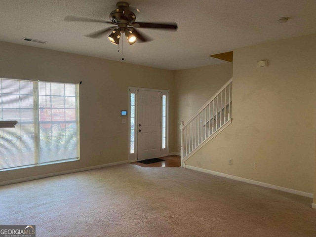 2858 Parkway Close, Lithonia, GA 30058 - carpeted foyer entrance with a ceiling fan, baseboards, and stairway