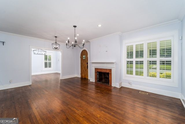 805 S Lee St, Fitzgerald, GA 31750 - unfurnished living room featuring a chandelier, a brick fireplace, wood finished floors, baseboards, and ornamental molding