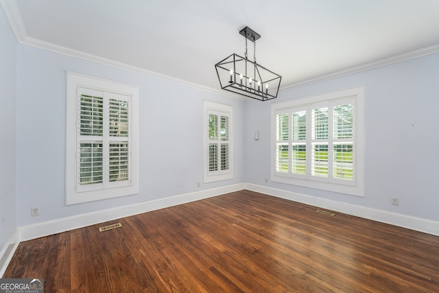 805 S Lee St, Fitzgerald, GA 31750 - unfurnished dining area featuring a chandelier, crown molding, baseboards, and dark wood-style flooring