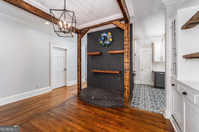 805 S Lee St, Fitzgerald, GA 31750 - unfurnished living room with a chandelier, dark wood-style flooring, crown molding, recessed lighting, and baseboards