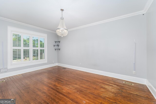 805 S Lee St, Fitzgerald, GA 31750 - spare room with ornamental molding, a chandelier, baseboards, and hardwood / wood-style floors
