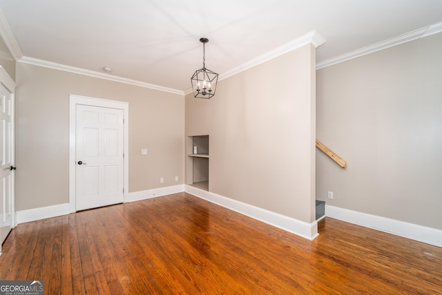 805 S Lee St, Fitzgerald, GA 31750 - empty room featuring crown molding, wood finished floors, a chandelier, and baseboards