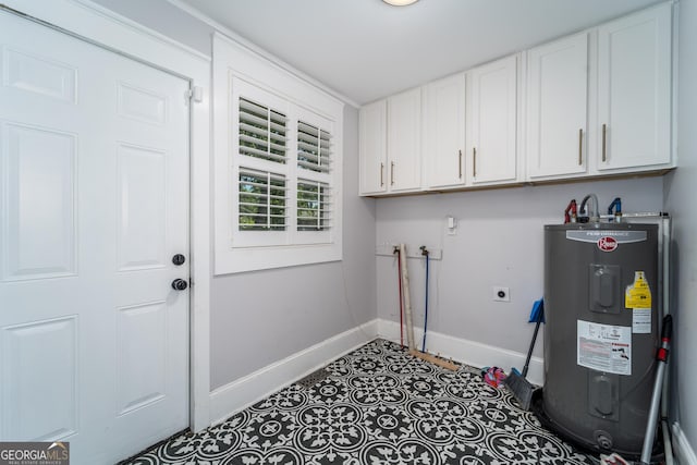 805 S Lee St, Fitzgerald, GA 31750 - laundry room featuring water heater, baseboards, cabinet space, and hookup for an electric dryer