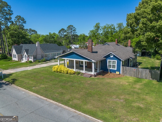 805 S Lee St, Fitzgerald, GA 31750 - view of front facade featuring a chimney, a porch, and view of scattered trees