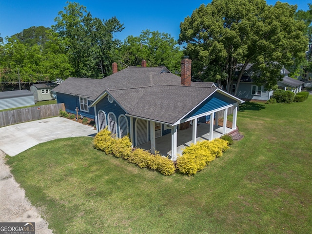 805 S Lee St, Fitzgerald, GA 31750 - exterior space with a chimney, a shingled roof, concrete driveway, and view of wooded area