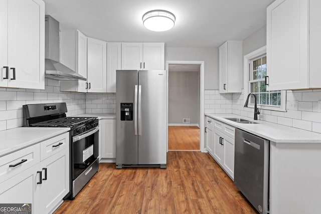 2002 Twin Falls Rd, Decatur, GA 30032 - kitchen featuring stainless steel appliances, wall chimney range hood, a sink, and white cabinets