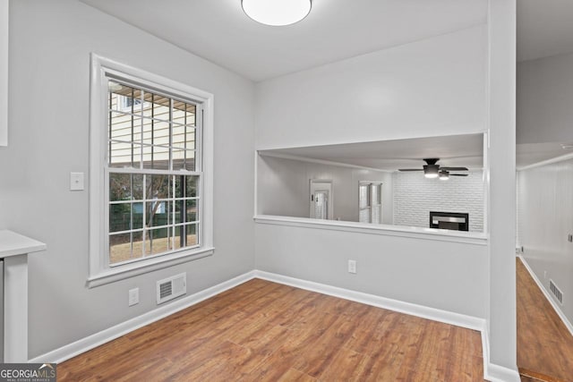 2002 Twin Falls Rd, Decatur, GA 30032 - unfurnished room featuring wood finished floors, ceiling fan, baseboards, and a fireplace