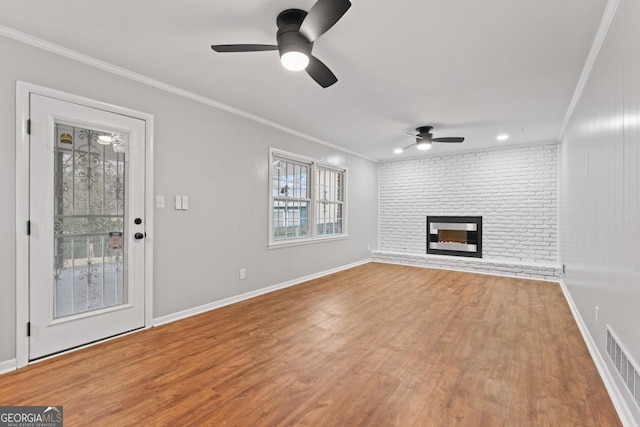 2002 Twin Falls Rd, Decatur, GA 30032 - unfurnished living room with a ceiling fan, crown molding, wood finished floors, a fireplace, and baseboards