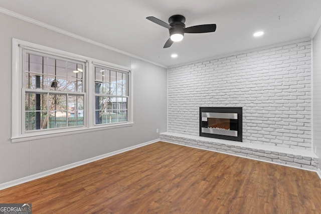 2002 Twin Falls Rd, Decatur, GA 30032 - unfurnished living room with crown molding, wood finished floors, a brick fireplace, ceiling fan, and baseboards