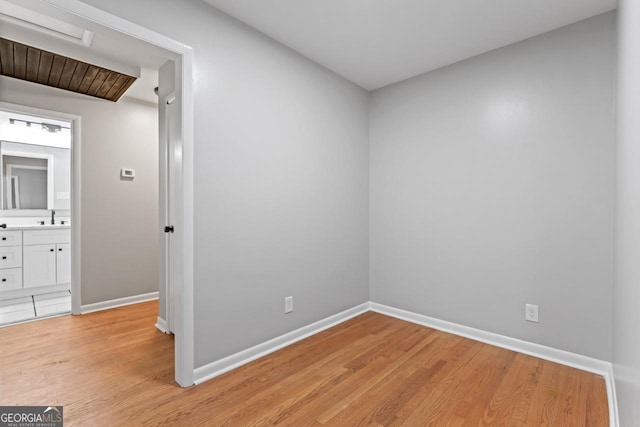 2002 Twin Falls Rd, Decatur, GA 30032 - unfurnished bedroom featuring light wood finished floors, baseboards, and a sink