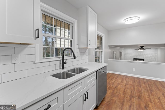 2002 Twin Falls Rd, Decatur, GA 30032 - kitchen featuring stainless steel dishwasher, a sink, decorative backsplash, a ceiling fan, and white cabinetry