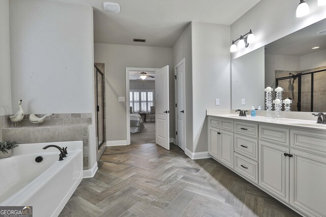 97 Senoya Ln, Senoia, GA 30276 - ensuite bathroom featuring a garden tub, a shower stall, double vanity, baseboards, and ceiling fan