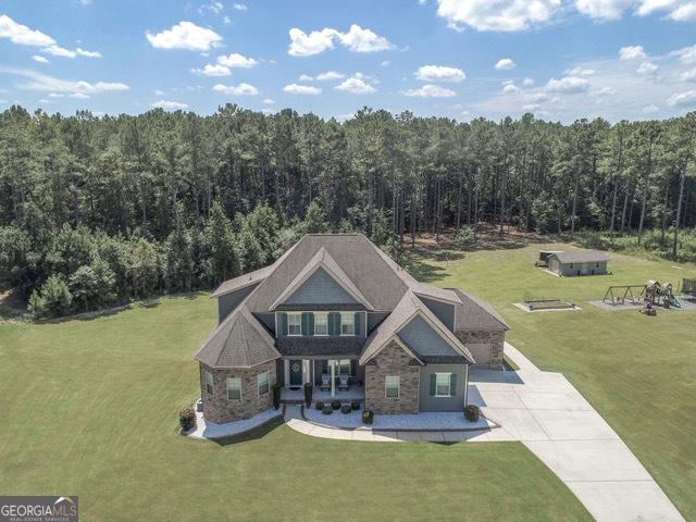 97 Senoya Ln, Senoia, GA 30276 - view of front facade with a view of trees, driveway, a front yard, and stone siding