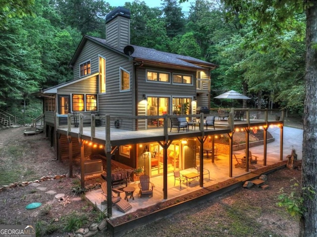 123 Old Fjord Rd, Blue Ridge, GA 30513 - back of house with a chimney, a wooden deck, a patio, and outdoor dining space