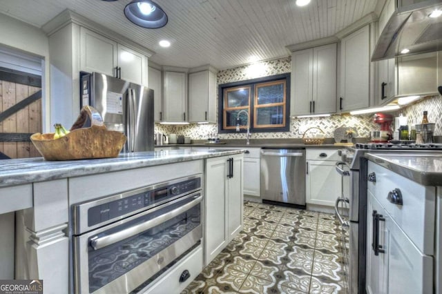 123 Old Fjord Rd, Blue Ridge, GA 30513 - kitchen featuring appliances with stainless steel finishes, wall chimney range hood, backsplash, a sink, and recessed lighting