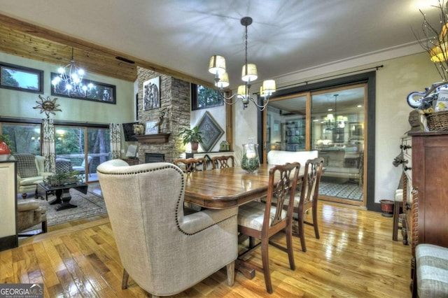 123 Old Fjord Rd, Blue Ridge, GA 30513 - dining room featuring a chandelier, hardwood / wood-style floors, and a stone fireplace