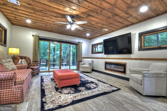 123 Old Fjord Rd, Blue Ridge, GA 30513 - living room with wood ceiling, wood finished floors, a glass covered fireplace, a ceiling fan, and plenty of natural light