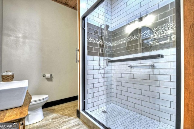 123 Old Fjord Rd, Blue Ridge, GA 30513 - bathroom featuring wood finished floors, a stall shower, toilet, and vanity
