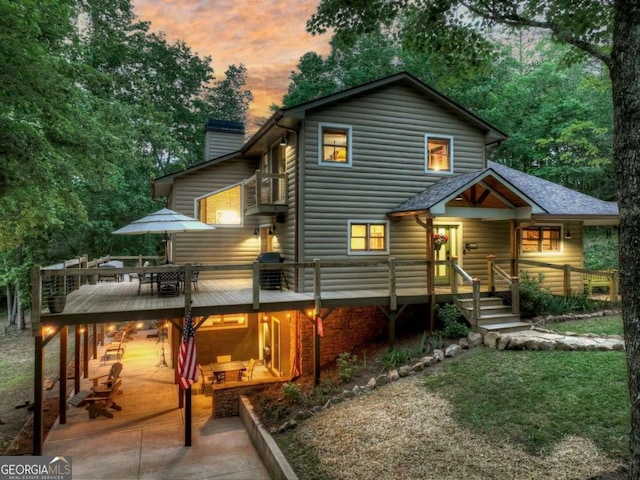 123 Old Fjord Rd, Blue Ridge, GA 30513 - rear view of house with a chimney, a deck, and outdoor dining area