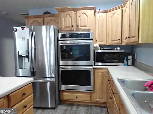 185 Kinards Mill Rd, Jackson, GA 30233 - kitchen with appliances with stainless steel finishes, light brown cabinetry, light countertops, and wood finished floors