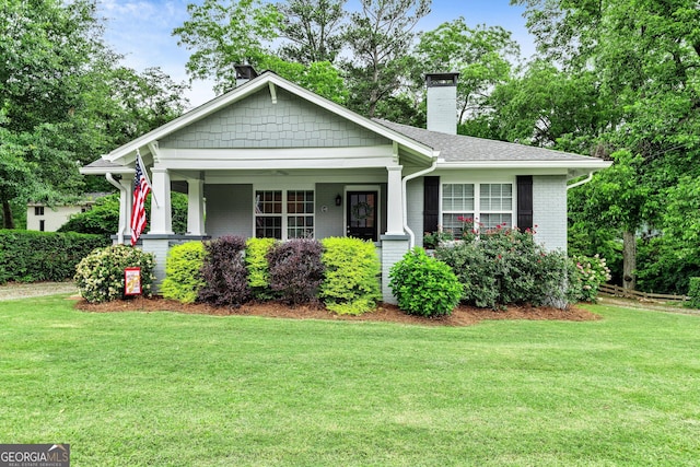 148 Jackson St, Newnan, GA 30263 - view of front of house with a chimney, a front yard, and a porch