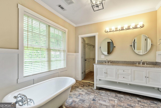 148 Jackson St, Newnan, GA 30263 - bathroom with a soaking tub, ornamental molding, double vanity, wainscoting, and a spacious closet