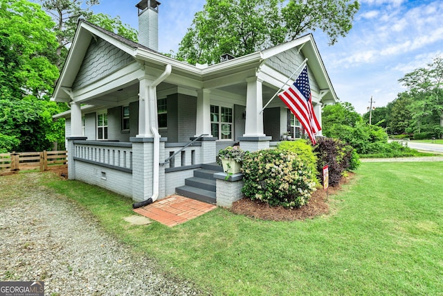 148 Jackson St, Newnan, GA 30263 - view of front of home featuring brick siding, covered porch, and a chimney
