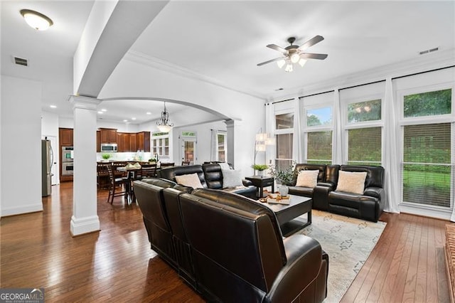 910 Ovalene Ln SW, Marietta, GA 30064 - living room with ornate columns, a ceiling fan, arched walkways, dark wood-style floors, and healthy amount of natural light
