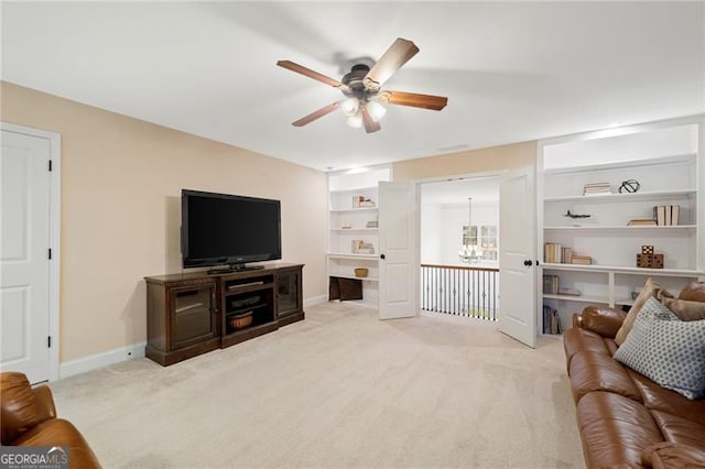 910 Ovalene Ln SW, Marietta, GA 30064 - carpeted living area with ceiling fan, a chandelier, and baseboards