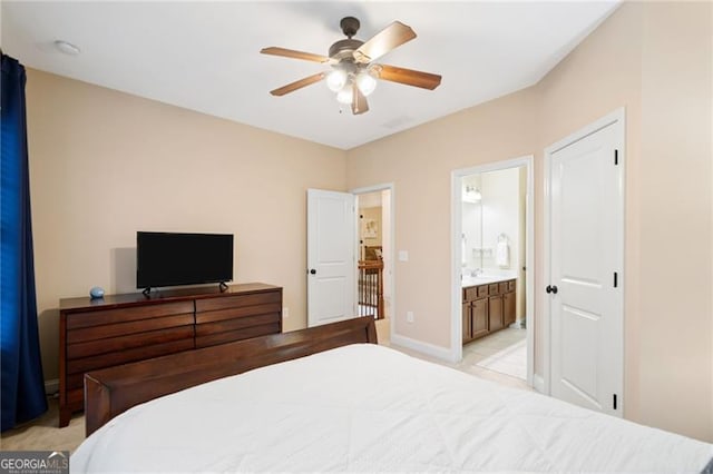 910 Ovalene Ln SW, Marietta, GA 30064 - bedroom featuring baseboards, ensuite bath, and ceiling fan