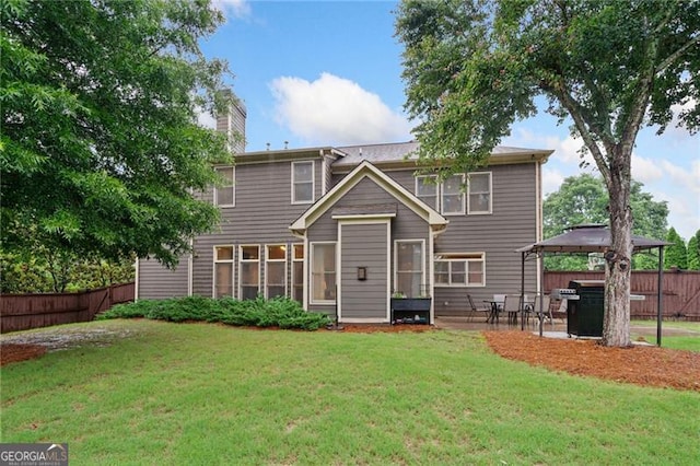 910 Ovalene Ln SW, Marietta, GA 30064 - back of property featuring a gazebo, a chimney, a patio, and a sunroom