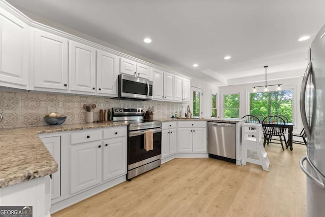 3652 Shady Oak Trl, Gainesville, GA 30506 - kitchen with stainless steel appliances, white cabinets, light wood-style floors, tasteful backsplash, and recessed lighting