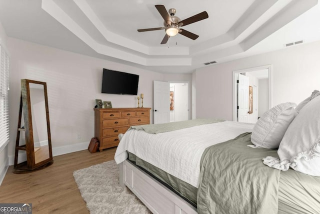 3652 Shady Oak Trl, Gainesville, GA 30506 - bedroom with a tray ceiling, light wood-style floors, and ceiling fan
