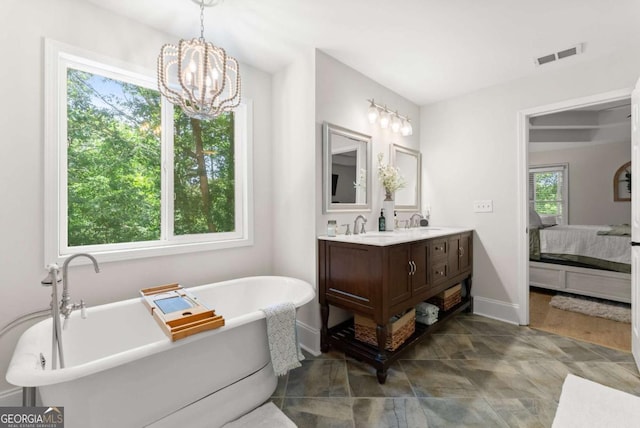 3652 Shady Oak Trl, Gainesville, GA 30506 - ensuite bathroom with double vanity, a soaking tub, and a chandelier