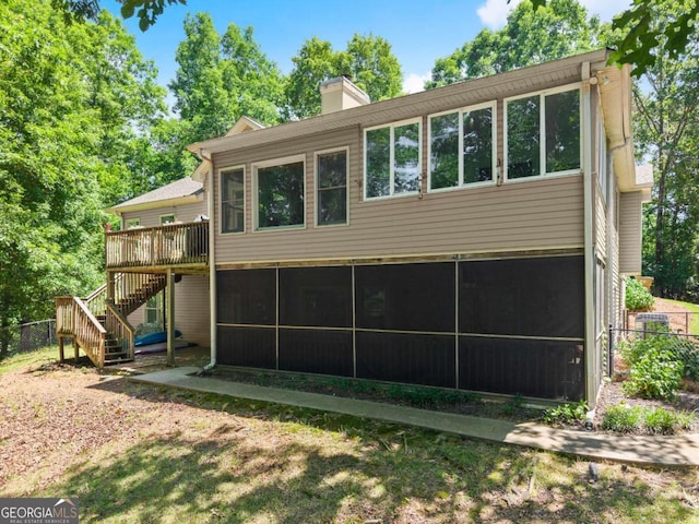 3652 Shady Oak Trl, Gainesville, GA 30506 - rear view of house with stairway, a sunroom, a deck, and a chimney
