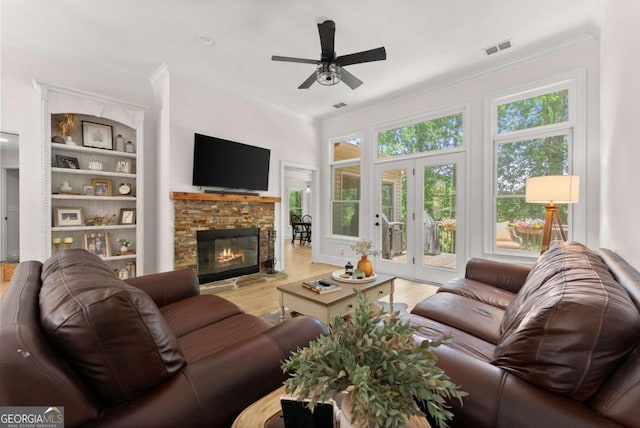 3652 Shady Oak Trl, Gainesville, GA 30506 - living room with ornamental molding, ceiling fan, wood finished floors, a fireplace, and french doors
