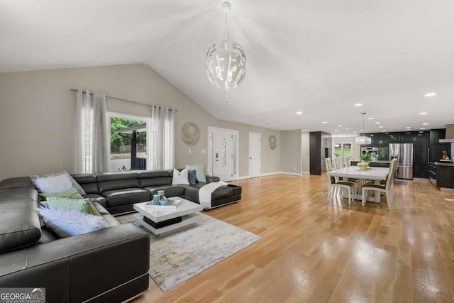 9701 Buice Rd, Alpharetta, GA 30022 - living area with plenty of natural light, light wood-type flooring, lofted ceiling, recessed lighting, and a chandelier