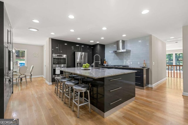 9701 Buice Rd, Alpharetta, GA 30022 - kitchen featuring modern cabinets, stainless steel appliances, wall chimney exhaust hood, a breakfast bar area, and decorative backsplash
