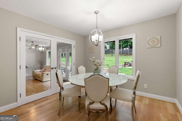 9701 Buice Rd, Alpharetta, GA 30022 - dining area featuring french doors, healthy amount of natural light, a chandelier, and light wood-style flooring