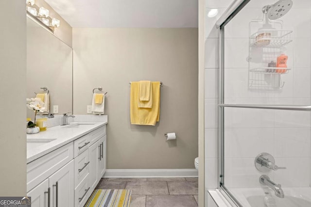 9701 Buice Rd, Alpharetta, GA 30022 - full bath featuring double vanity, toilet, enclosed tub / shower combo, tile patterned flooring, and baseboards