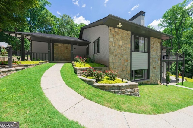 9701 Buice Rd, Alpharetta, GA 30022 - view of property exterior featuring stone siding, a chimney, and a yard