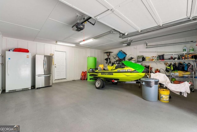 9701 Buice Rd, Alpharetta, GA 30022 - garage featuring freestanding refrigerator and a garage door opener