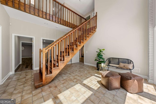 9701 Buice Rd, Alpharetta, GA 30022 - stairs with a high ceiling and baseboards