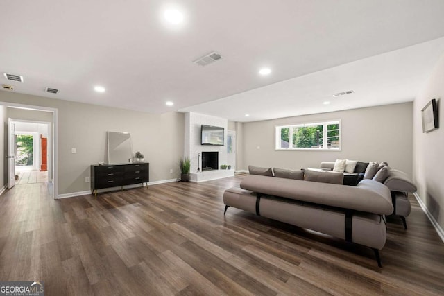 9701 Buice Rd, Alpharetta, GA 30022 - living room featuring wood finished floors, recessed lighting, baseboards, and a brick fireplace