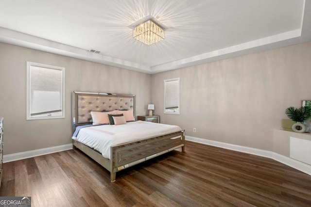 9701 Buice Rd, Alpharetta, GA 30022 - bedroom featuring wood finished floors, baseboards, a chandelier, and a tray ceiling